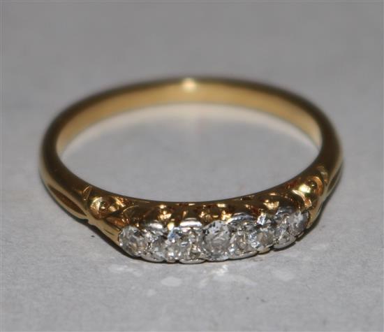 An early 20th century 18ct gold and five stone diamond half hoop ring, size M.